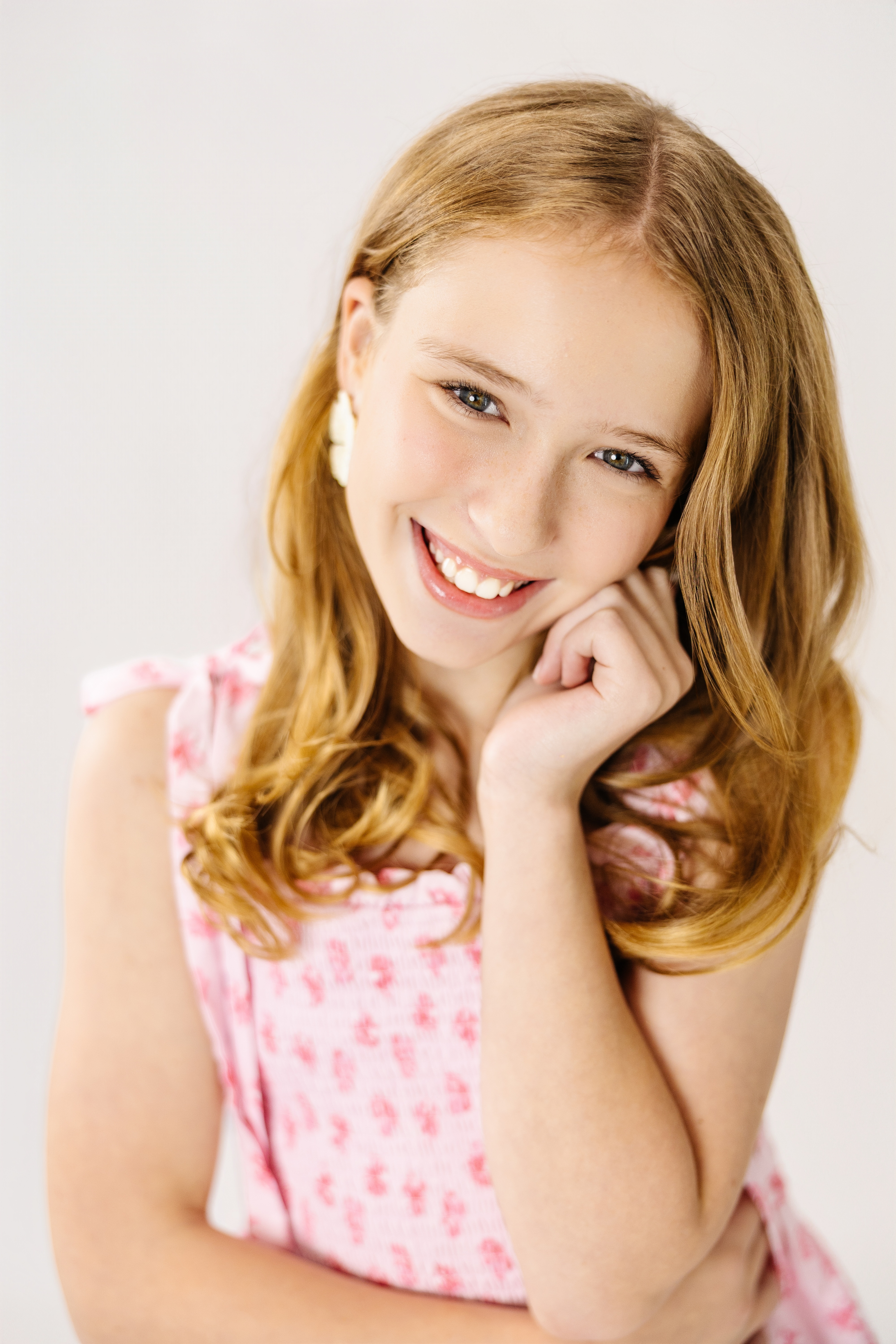 Georgia smiling in a pink floral dress
